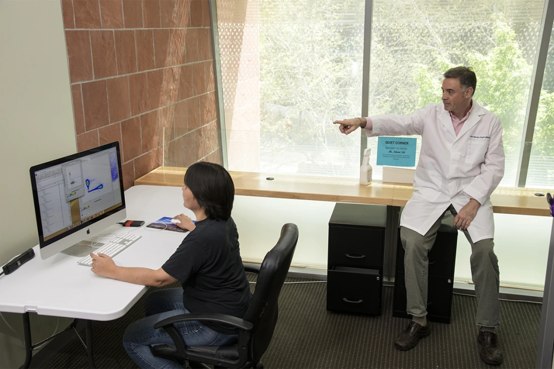 Makiko Watanabe, DVM, PhD, (left), and Janko Nikolich-Žugich, MD, PhD (right), review the results of a preliminary assay that sheds light on the immune response to the virus that causes COVID-19. Their work in the spring led to the community antibody testing the University of Arizona has been conducting since April.