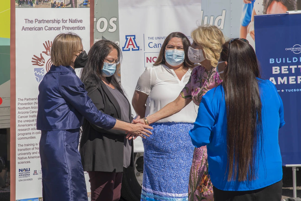 Joann Sweasy, PhD, (left) director of the UArizona Cancer Center, greets first lady Jill Biden, EdD, during her visit to the San Xavier Health Center in the San Xavier District of the Tohono O'odham Nation on March 8, 2022. 