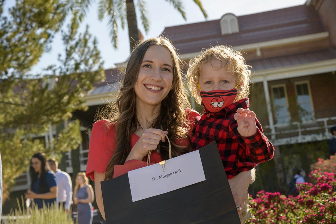 Morgan Goff holds her son Hans Ashby before she can open the envelope that will tell Goff where she has been matched during the UArizona College of Medicine – Tucson 2022 Match Day event.