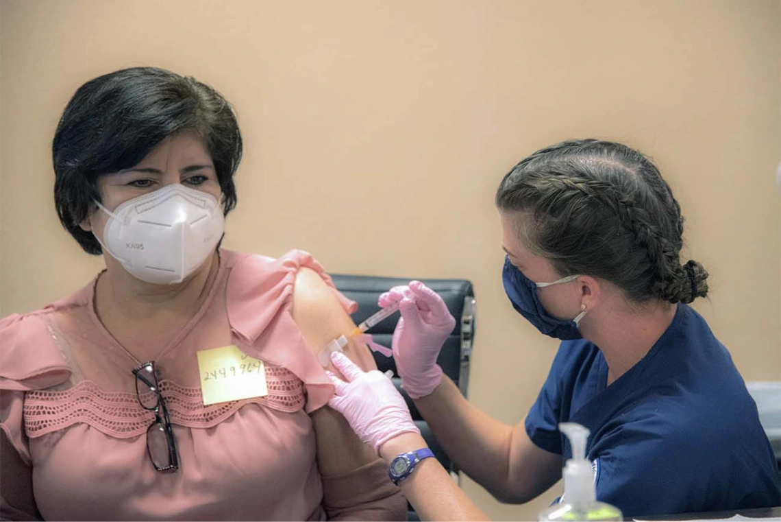 College of Nursing student Kathleen Gies vaccinates a patient at a MOVE UP COVID-19 clinic held by UArizona Health Sciences in Douglas, Ariz., in partnership with the Cochise County Health Department and Consulate of Mexico.