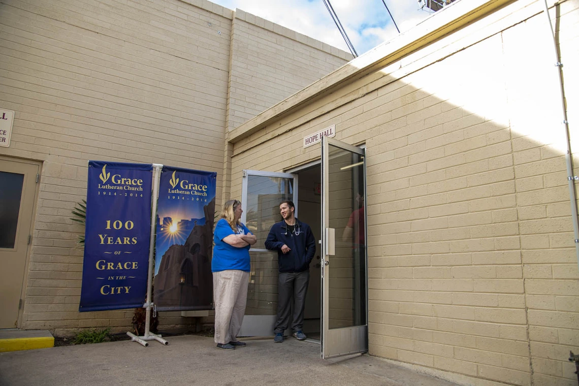 Street Medicine Phoenix co-founder Justin Zeien, right, speaks with a fellow volunteer in front of Grace Lutheran Church.