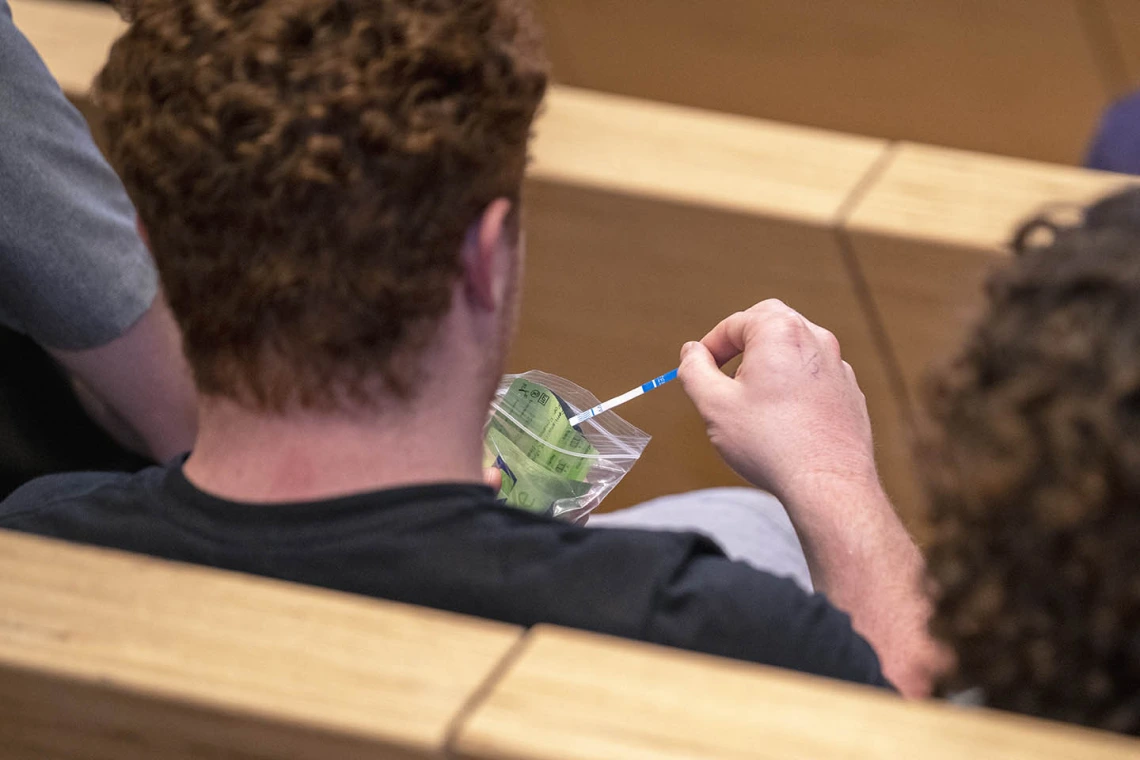 A student examines a Rapid Response testing kit, used to determine if drugs are laced with fentanyl, during the Drug Survival 102 panel presentation.