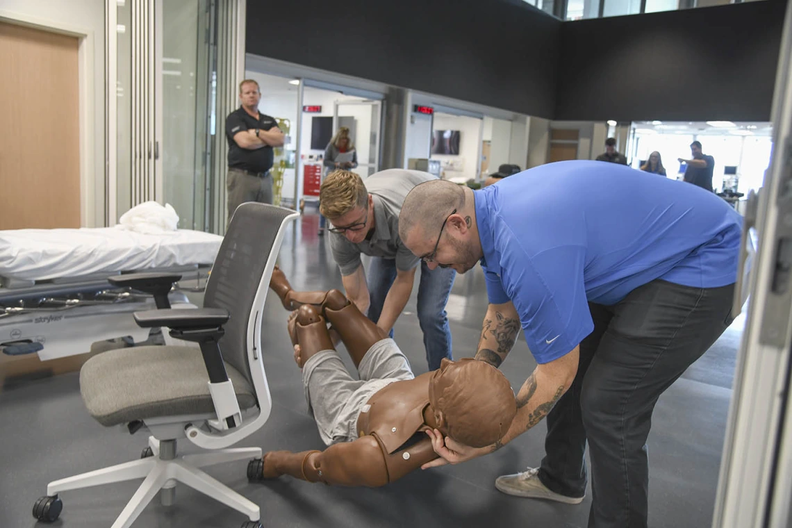 Using lifelike manikins, ASTEC personnel train staff from a local drug rehab facility to treat overdose with naloxone.