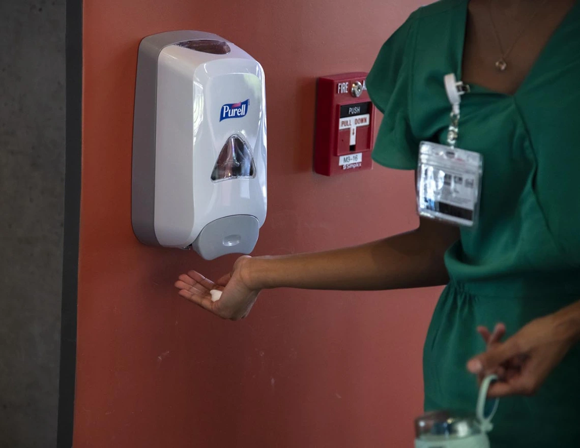 First-year College of Medicine – Tucson student Andria Albert sanitizes her hands before entering the Health Sciences Innovation Building.