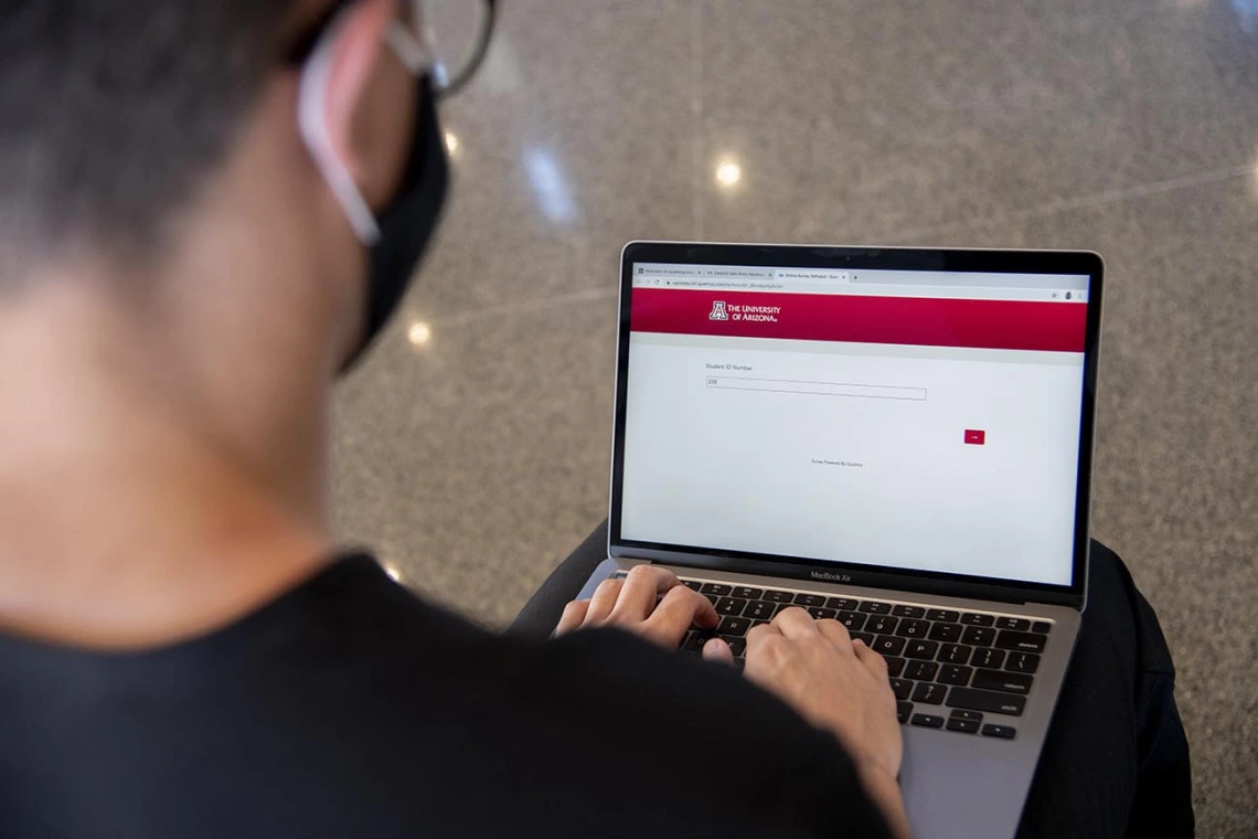 First year College of Medicine – Tucson student Charles Andrew Jauregui checks into Daily Wellness Screening on his laptop before heading to a class. The wellness checks must be completed using the Wildcat WellCheck screening tool, which allows employees and students to self-screen for symptoms.