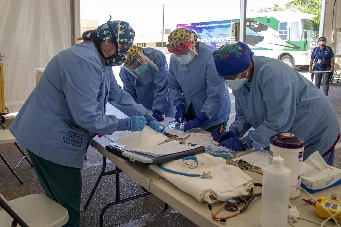 Tuba City Regional Health Care nurses and doctors working in a tent set up for COVID-19 testing.