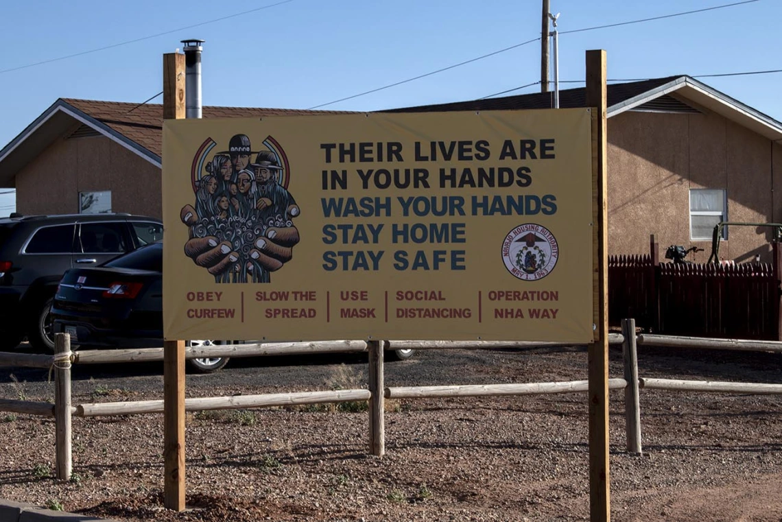 Signs and billboards are posted throughout the Navajo Nation asking tribal members to protect their family from COVID-19 by washing their hands and staying home. 