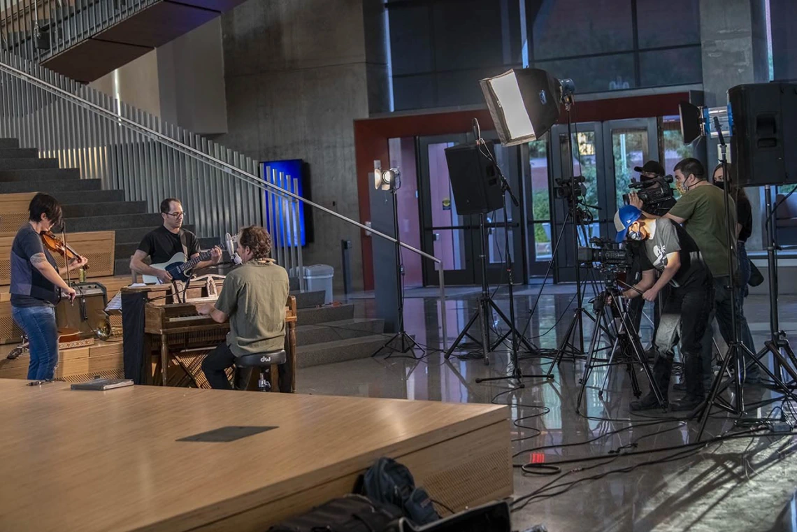 At the base of The Forum, musicians and a film crew prepare for a live-streamed music event.