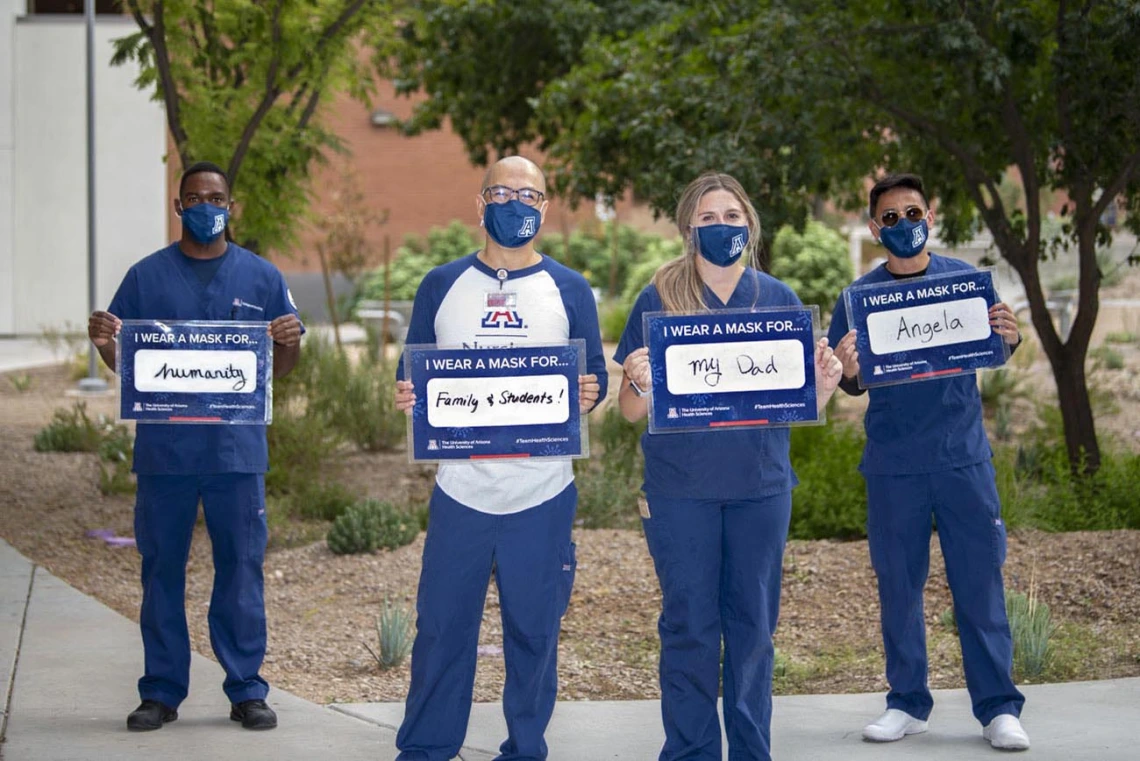 Decked out in UA Blue, from left: Aden Abdi, Philip Moya, MSN, BSN, RN, Kayla Killigrew and Nicolo Abrugena from the College of Nursing pose for the campaign. Moya is a clinical nursing instructor. Abdi, Killgrew and Abrugena are fourth-year nursing students. 