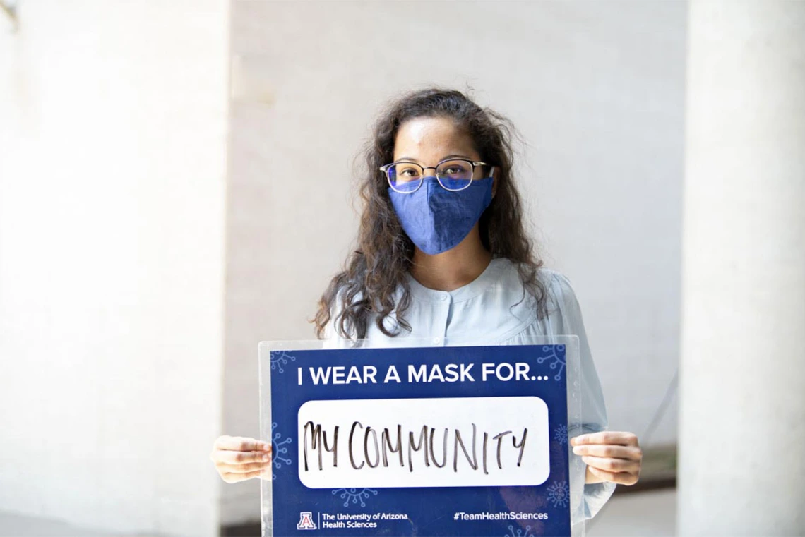 First-year College of Medicine – Phoenix student Prathima Harve holds a sign that says she wears a mask for her community. Harve is one of 32 students from the Colleges of Medicine in Tucson and Phoenix to be awarded a Primary Care Physician Scholarship this fall. 