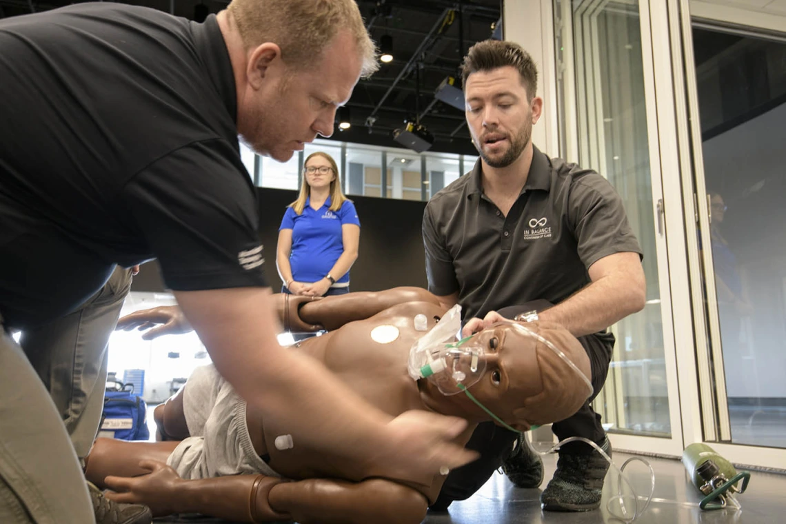 Using lifelike manikins, ASTEC personnel train staff from a local drug rehab facility to treat overdose with naloxone.