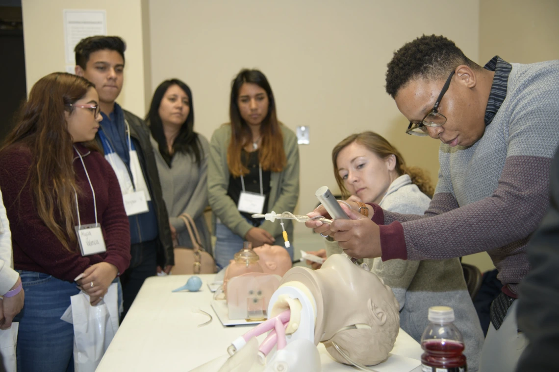 An anesthesiology specialist gives a demonstration on intubation.