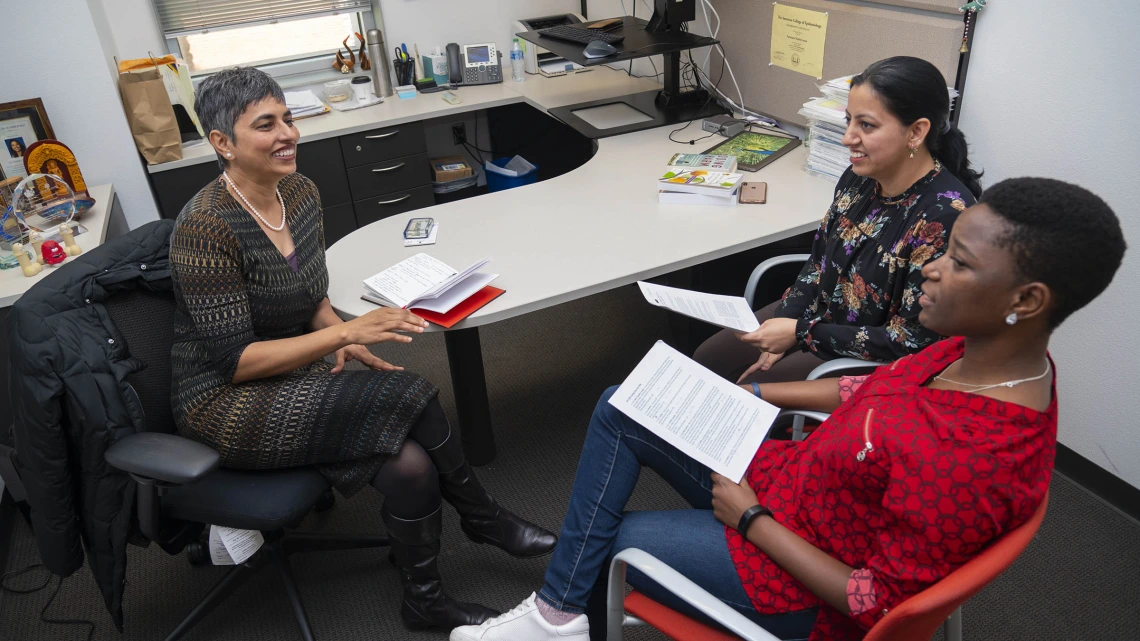 (Left) Purnima Madhivanan, PhD, MBBS, MPH, an associate professor of health promotion in the Mel and Enid Zuckerman College of Public Health, meets with two of her mentees, (center) Kiranmayee Muralidhar, MMBS, MPH, and Namoonga Mantina, both doctoral students, to discuss progress on their research manuscripts. Madhivanan is currently mentoring about 35 people. 