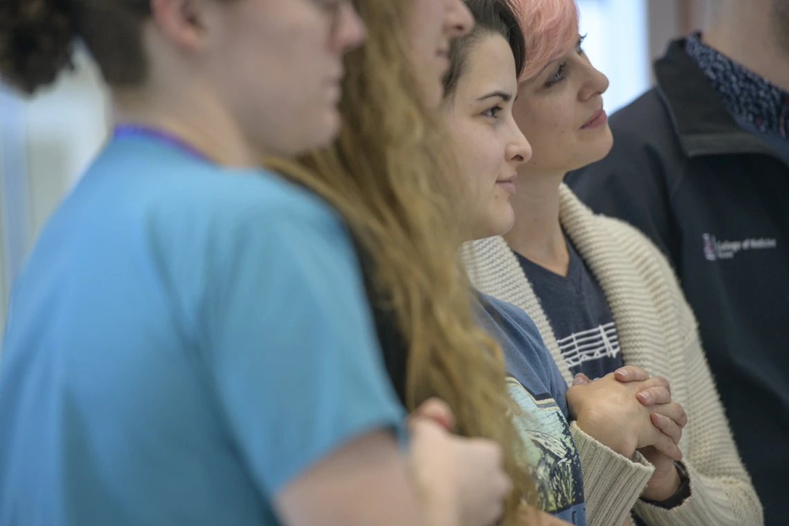 Members of Doc-acapella listen to other speakers.