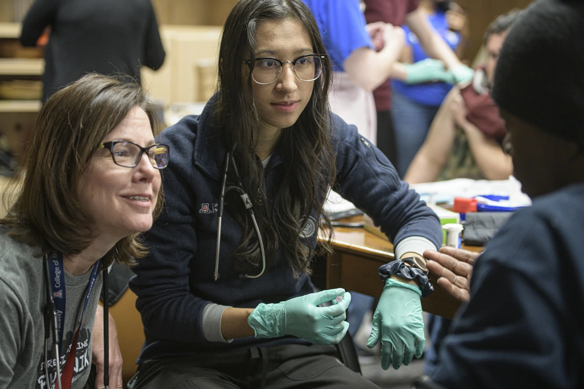 Street Medicine Phoenix preceptor Susan Kaib, MD, and first-year College of Medicine - Phoenix student volunteer Sara Yee get to know a patient.