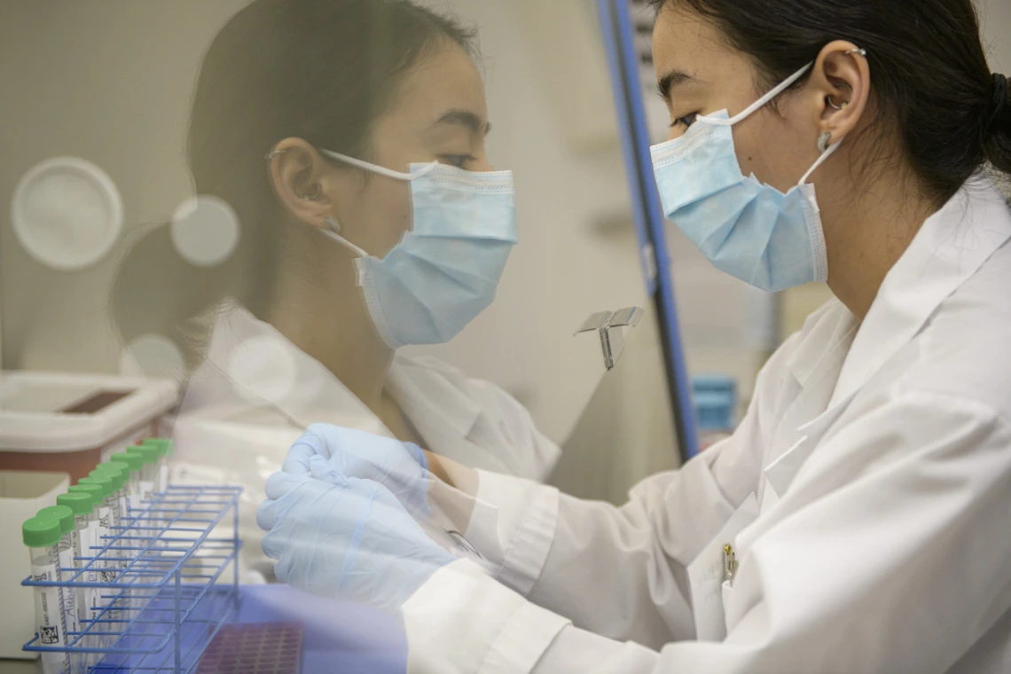 Lab technician Cindy Bujanda places a set of antigen sample tubes under a hood in the testing laboratory. Students and staff receive nasal swab results within two hours. 