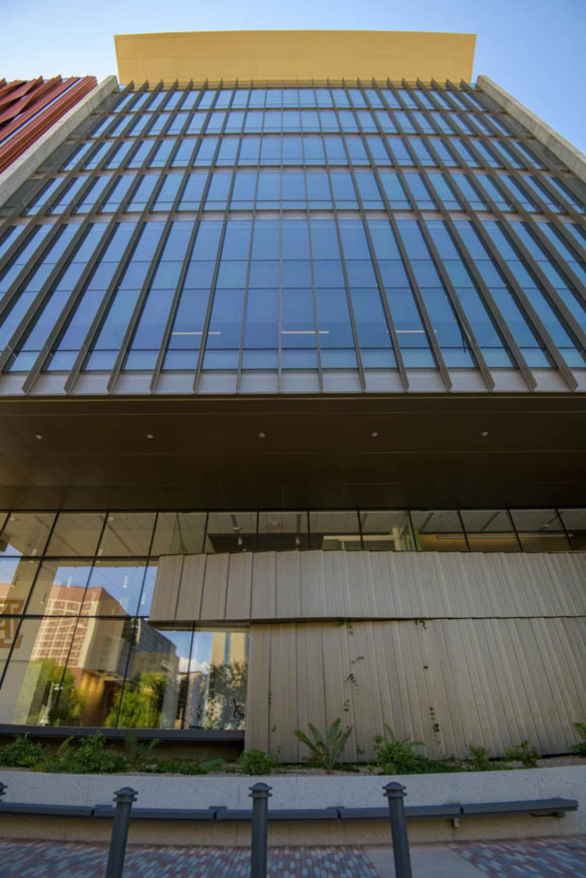 The south-facing exterior of the building features expansive views, and the upper floors are fitted with SageGlass. The material works like photochromic glasses that automatically darken when exposed to sunlight. They help block excess light while allowing views of summertime monsoons, soaring hawks and the Santa Rita Mountains.