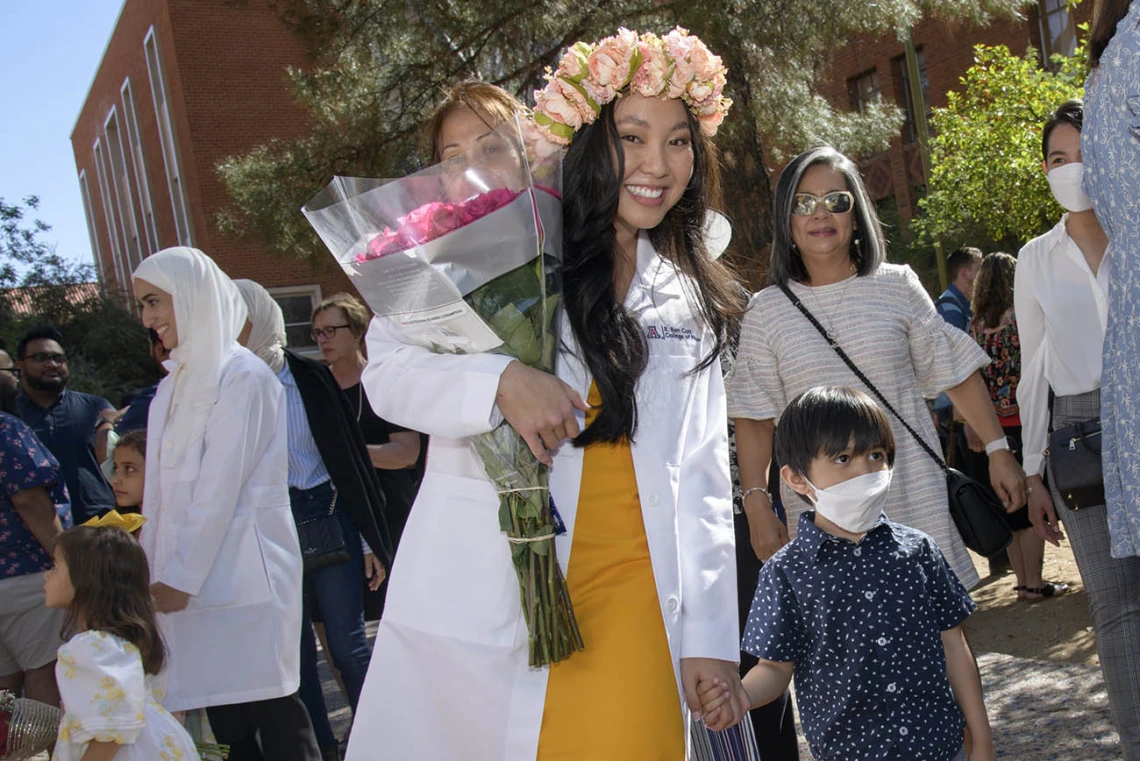 Allysa Mae Ong celebrates with her son, Arvel Zuri, after the R. Ken Coit College of Pharmacy class of 2023 white coat ceremony. 