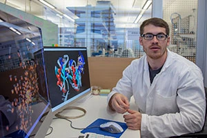 David Scott shows a colleague a molecule he helped create. Photo by Nadia Whitehead / UA College of Medicine – Tucson