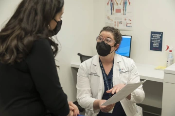 Dr. Mercer, an associate professor of obstetrics and gynecology at the University of Arizona College of Medicine – Phoenix, speaks with a coworker in a clinical skills suite at the Health Sciences Education Building on the Phoenix campus. 