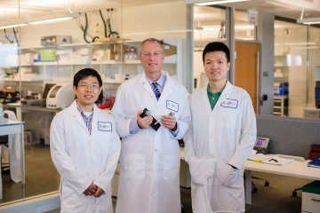 Associate Professor Jian Gu, PhD and Frederic Zenhausern, PhD, MBA, in their lab where they work together on a Department of Defense contract. Peng Chen, PhD, was a postdoctoral researcher in the lab until Oct. 2018.