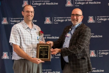 Joshua Lee, MD, (right) clinical associate professor of medicine and physician executive at Banner Health, presents the Clinical Excellence Award to Dr. Nathan Price.