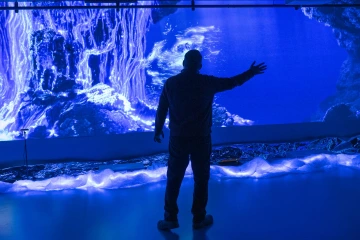 person interacting with immersive art 