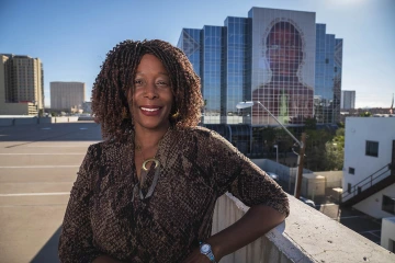 Black woman standing on rooftop on College of Medicine - Phoenix campus.