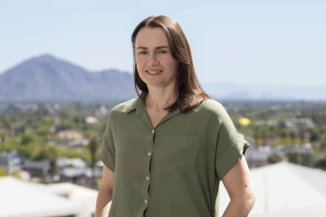 Portrait of Halszka Glowacka outside with mountains and cityscape of Phoenix in the background.