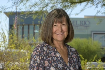 Portrait image of Nancy Johnson in front of the El Rio Health Cherrybell building