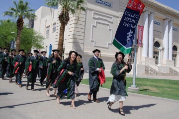 The class of 2022 beginning their walk on the Phoenix Bioscience Core.