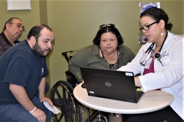 Nurse explains data captured by CardioMEMS to patient.