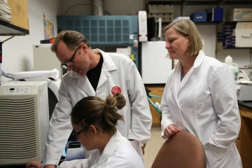 Bonnie Hurwitz, PhD, pictured here with associate professor of pharmacology George Watts, PhD, and research specialist Candice Clark-Mason, uses data science to solve health problems in the lab.