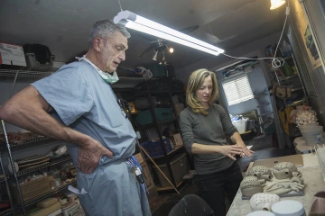 Ceramic artist Danielle Wood shows her progress in making ceramic representations of various mechanical heart implant devices to Michael Murray, MD, PhD, MCCM, a professor of anesthesiology and internal medicine at the College of Medicine – Phoenix.