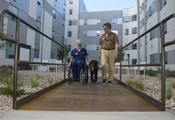 Nick Knapton talks with Victor Braitberg, PhD, from the UArizona Honors College. Nick’s service dog is Herbert Walter Esquire.