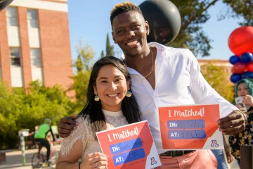 Caylan Bookman, MD, (right) and Naiby Rodriguez, MD, celebrate on Match Day 2022.