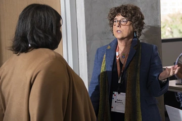 Taren Ellis Langford, JD, of the Conflict of Interest office speaks to Esther Sternberg, MD, during the grand opening of the Faculty Commons + Advisory event inside the Health Science Innovation Building.