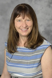 Woman with brown hair sits for a portrait