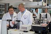 Dr. Frederic Zenhausern, right, director of the Center for Applied NanoBioscience and Medicine, works with Matthew Barrett, a senior research specialist. (Photo: Sun Czar Belous/University of Arizona College of Medicine – Phoenix)