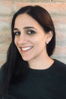 Portrait of a smiling young woman with long dark hair. 