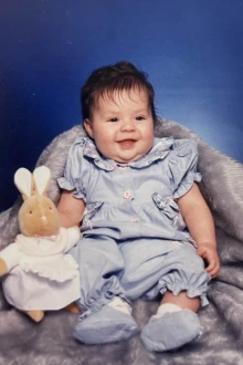 portrait of an infant with a stuffed animal