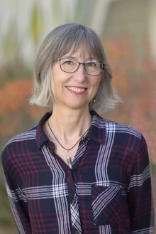 Portrait of Aleeca Bell, PhD, standing outside smiling.