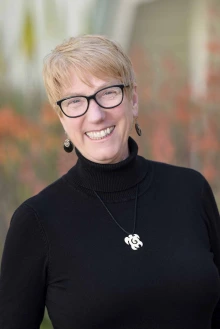 Portrait of Shelley McGrew, DNP, standing outside smiling.