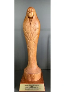 The Dr. Loui Olivas Distinguished Leadership in Higher Education Award is a woodcarving made by Phoenix-based, internationally acclaimed artist Zarco Guerrero.