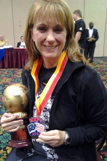 Dr. Gerald with some of her powerlifting awards. She held state and national records, albeit briefly, in three categories. Among those was the strict bicep curl national record for her age group, which she won in 2013. 